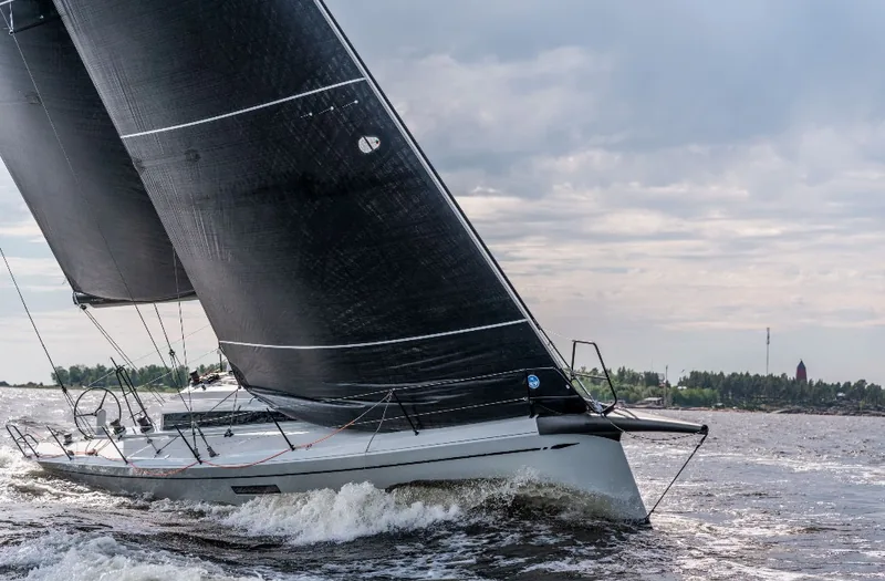 ClubSwan 43 sailing upwind under black sails